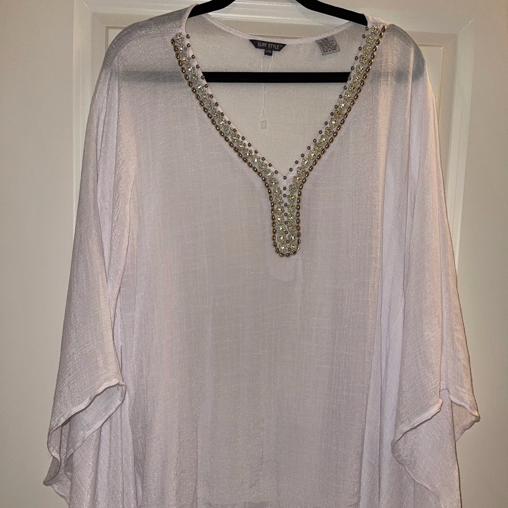 white coverall with beaded trim.